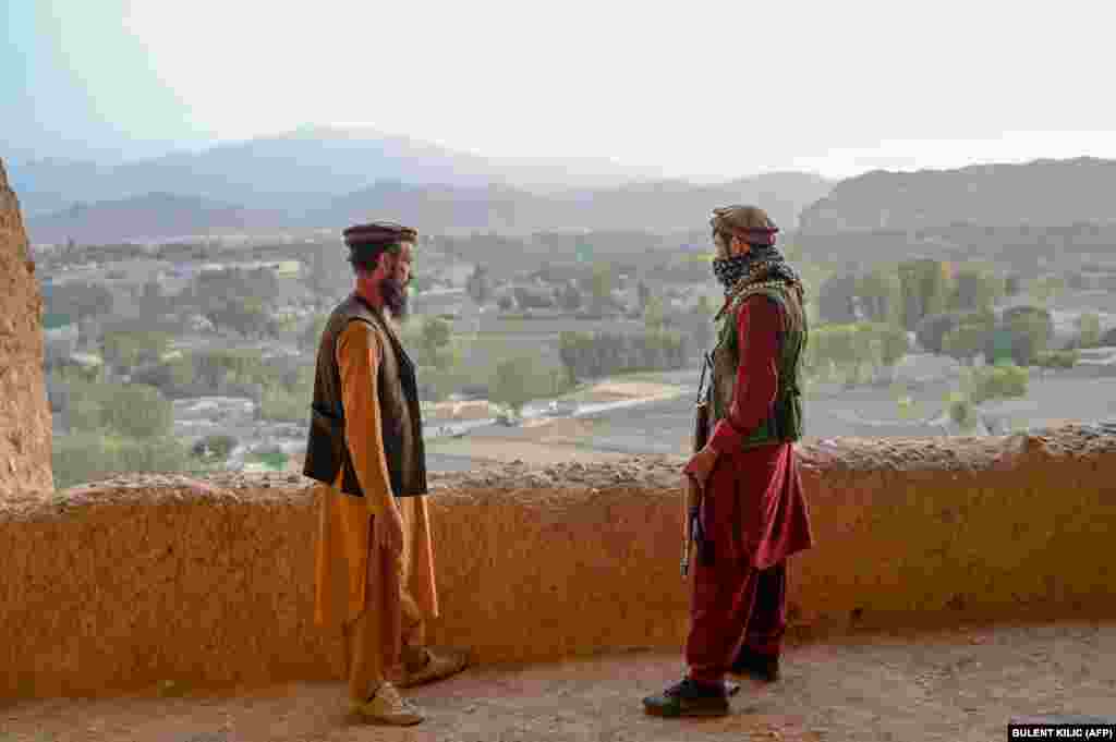 Members of the Taliban stand at the site, which was added to a UNESCO list of endangered cultural sites in 2003. 