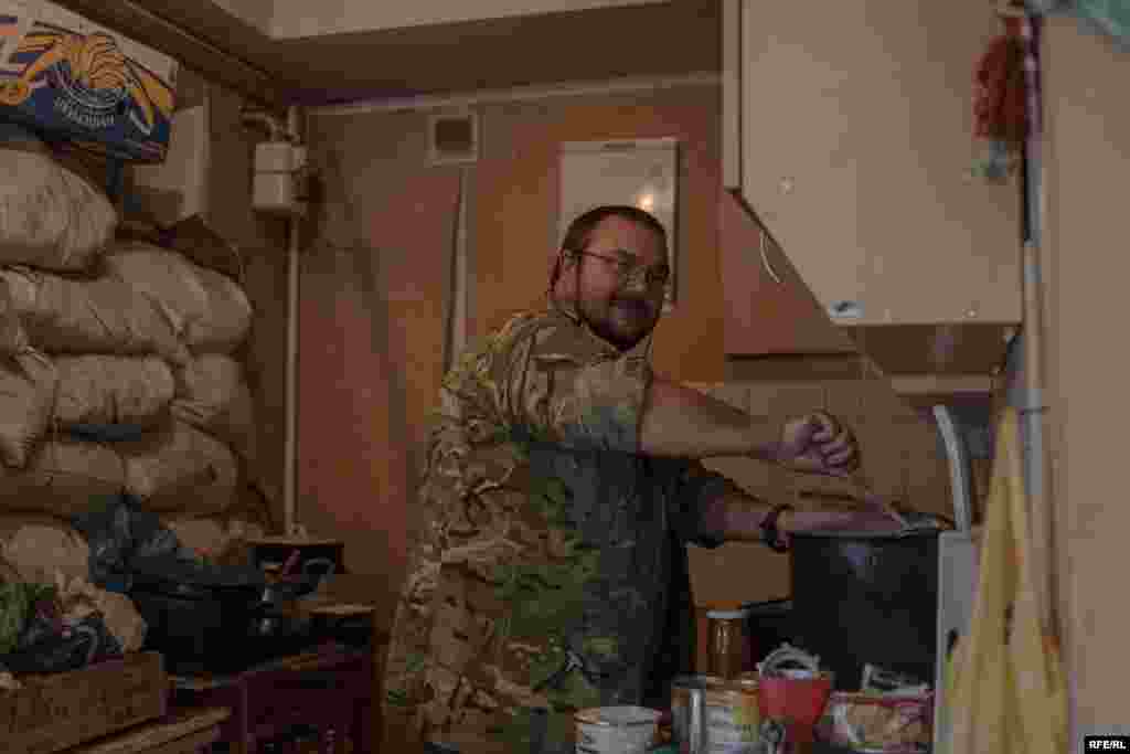 "Tuna" makes dinner. He once ran his own business, but joined the unit a few months ago and pays monthly salaries to some of the fighters out of his own pocket.