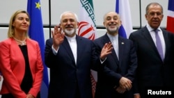 Austria -- Iranian Foreign Minister Mohammad Javad Zarif (2nd L) gestures next to EU foreign policy chief Federica Mogherini (L), Iranian ambassador to IAEA Ali Akbar Salehi (2nd R) and Russian Foreign Minister Sergei Lavrov (R) as they pose for a photo in Vienna, 14Jul2015.