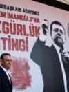 Лидер партии CHP Озгюр Озель на фоне портрета арестованного мэра Стамбула Экрема Имамоглу 