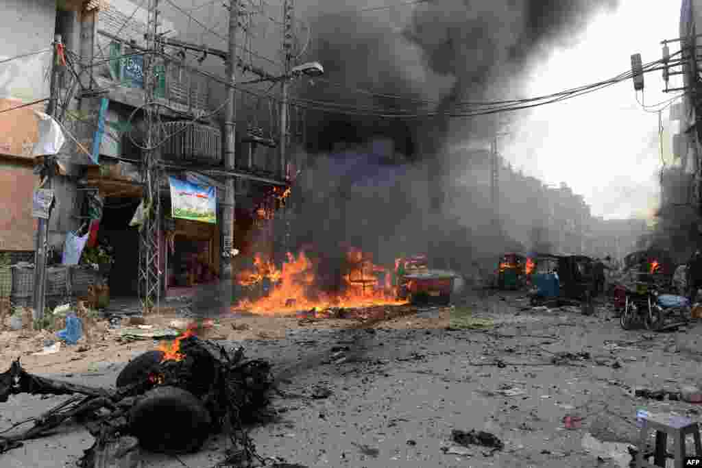 The blasts set shops and cars ablaze along the narrow market corridor. One eyewitness said he watched helplessly as a group of women and children burned to death in their car.