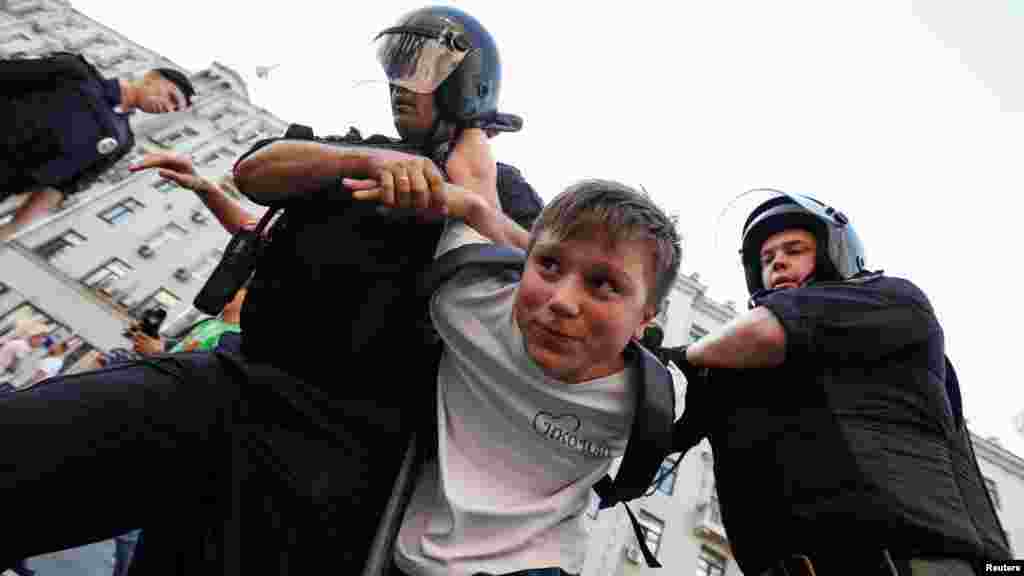 A youngster is detained in Moscow. According to a recent survey, some 90 percent of Russians oppose the plan to raise the retirement age, and a recent poll by the Levada Center polling agency found that more than 50 percent of Russians say they would participate in protests against it.