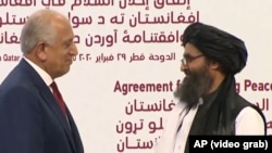 ارشیف، د افغان سولې لپاره د امریکا ځانګړی استازی زلمی خلیلزاد او قطر کې د طالبانو د سیاسي دفتر مشر ملا برادر